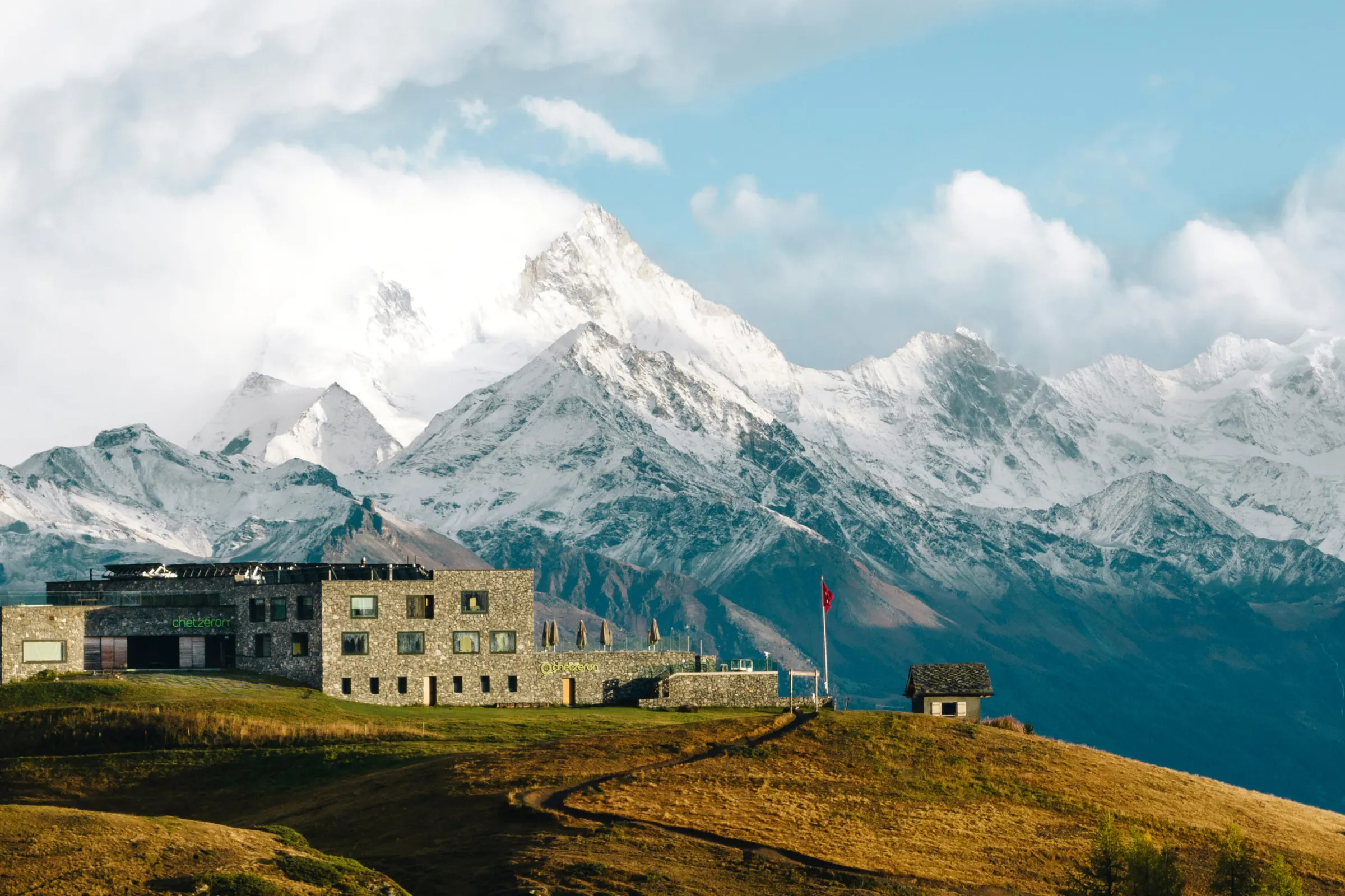 Chetzeron on an alpine meadow above Crans-Montana with mountains beyond