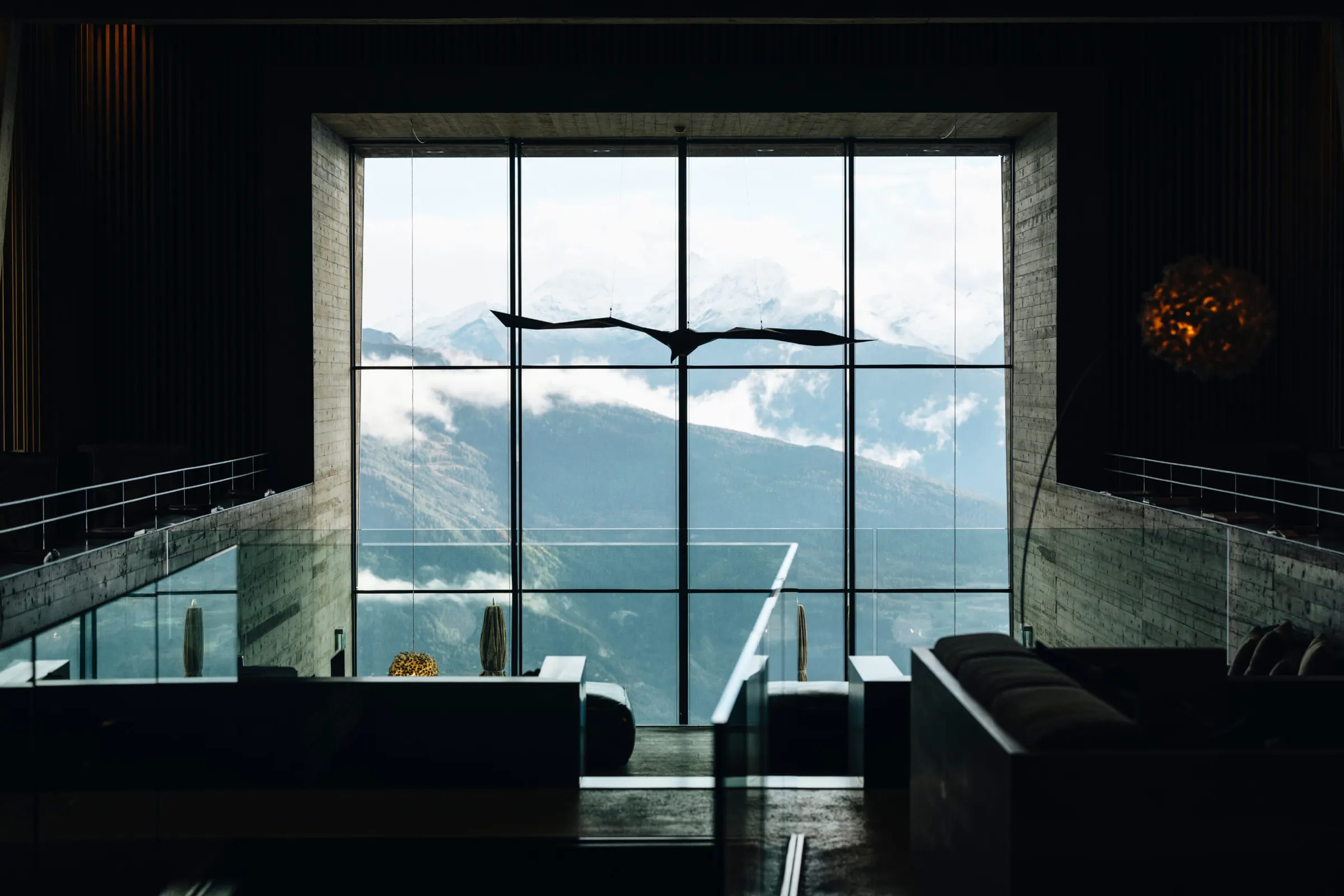 Chetzeron lobby window framing the mountains above Crans-Montana