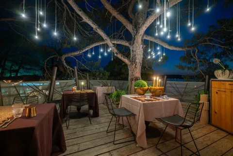 Treehouse Restaurant at Ekies All Senses Resort illuminated in the evening