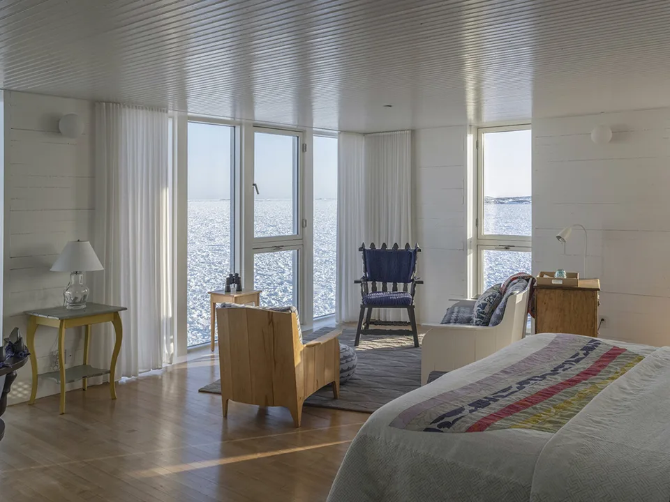 Bright guest room with handcrafted furniture and Atlantic views at Fogo Island Inn