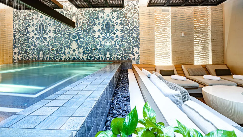 Indoor spa pool with sculptural lighting at Kimpton Seafire