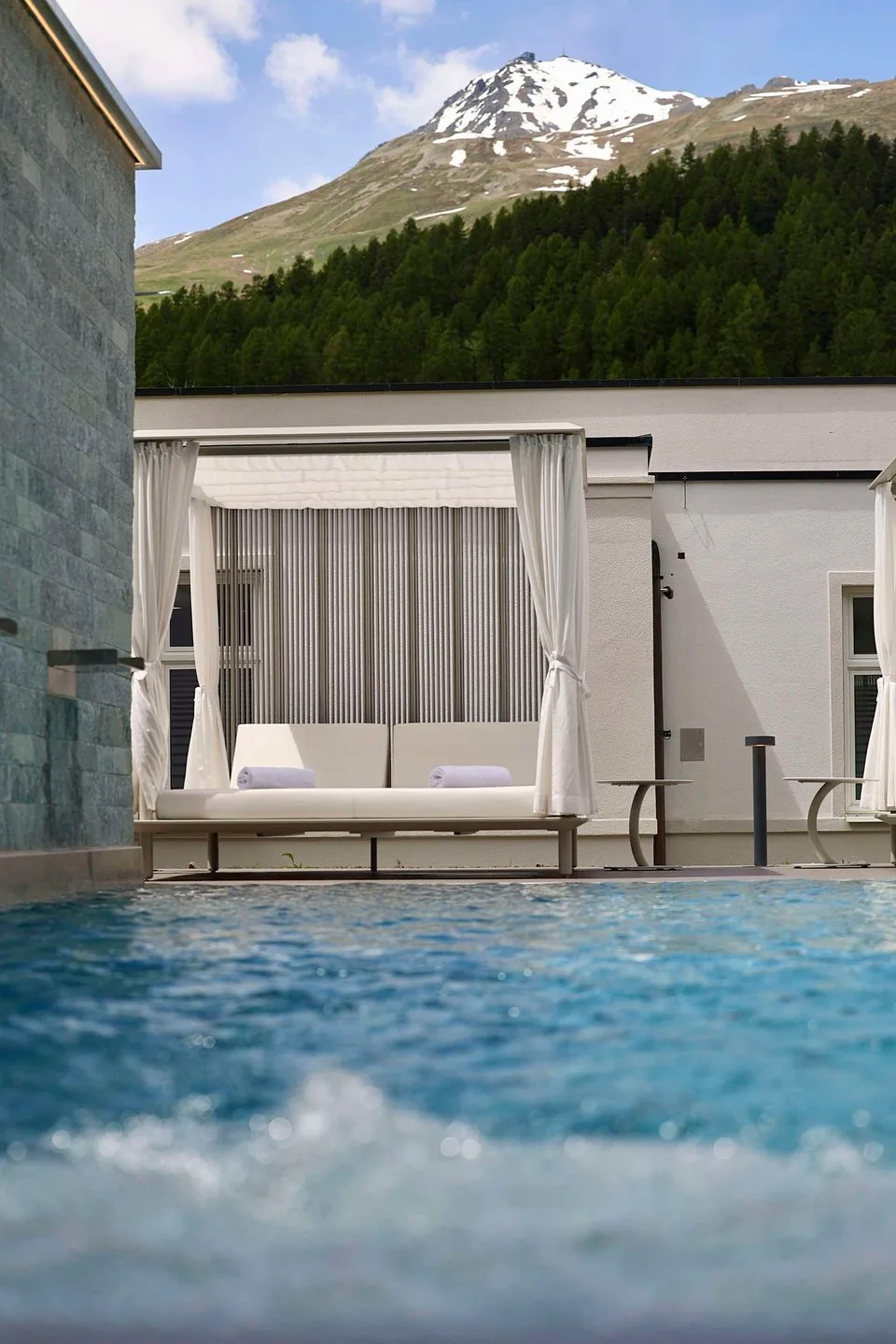 Outdoor spa pool with mountain backdrop at Grand Hotel des Bains Kempinski St. Moritz