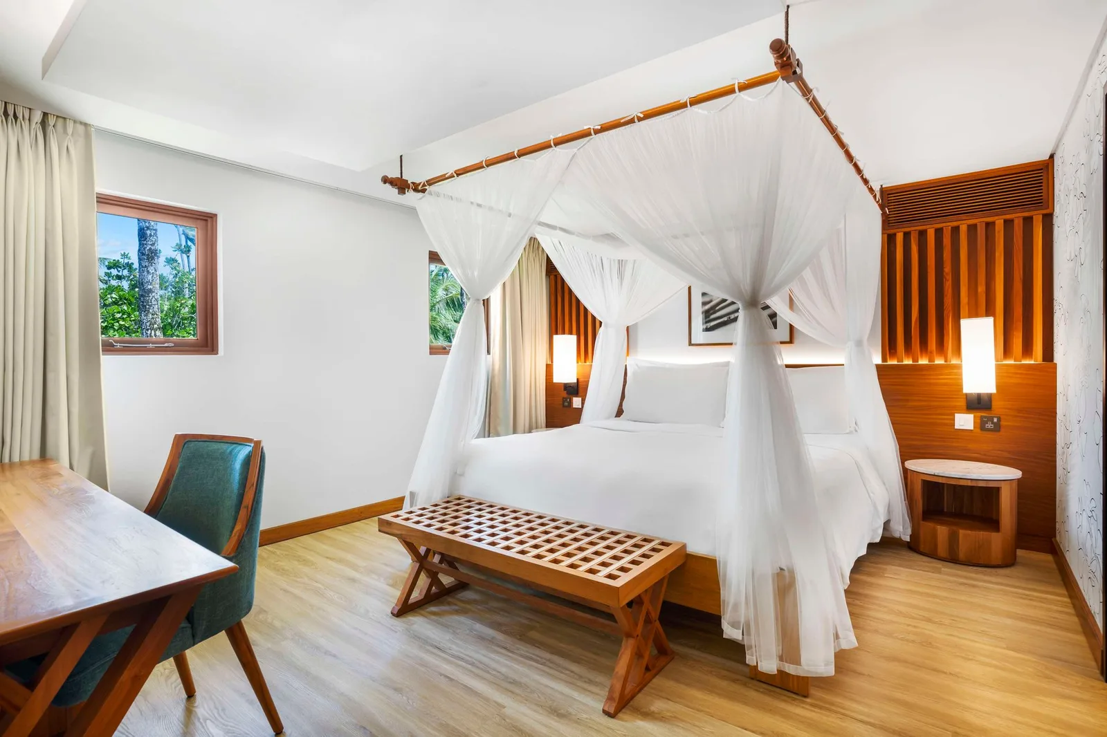 Guestroom with draped bed at Kempinski Seychelles Resort Baie Lazare