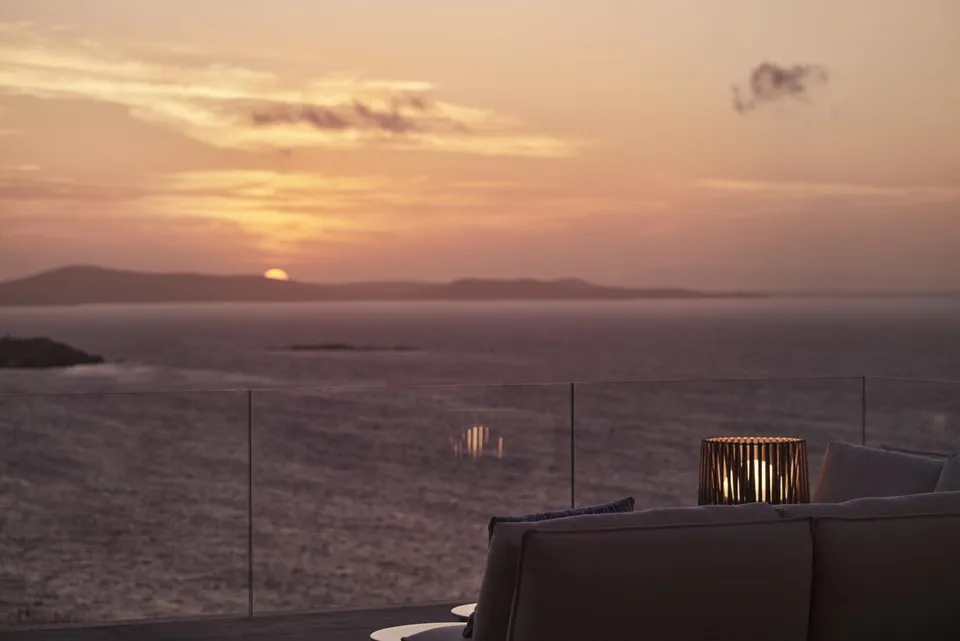 Private terrace overlooking the Aegean at sunset at Myconian Deos