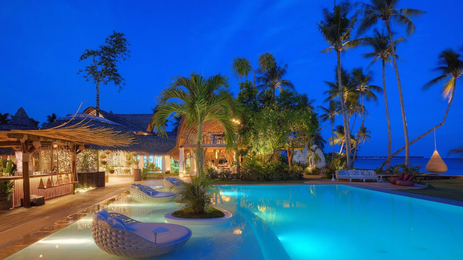 Nay Palad Hideaway pool and villas illuminated at night