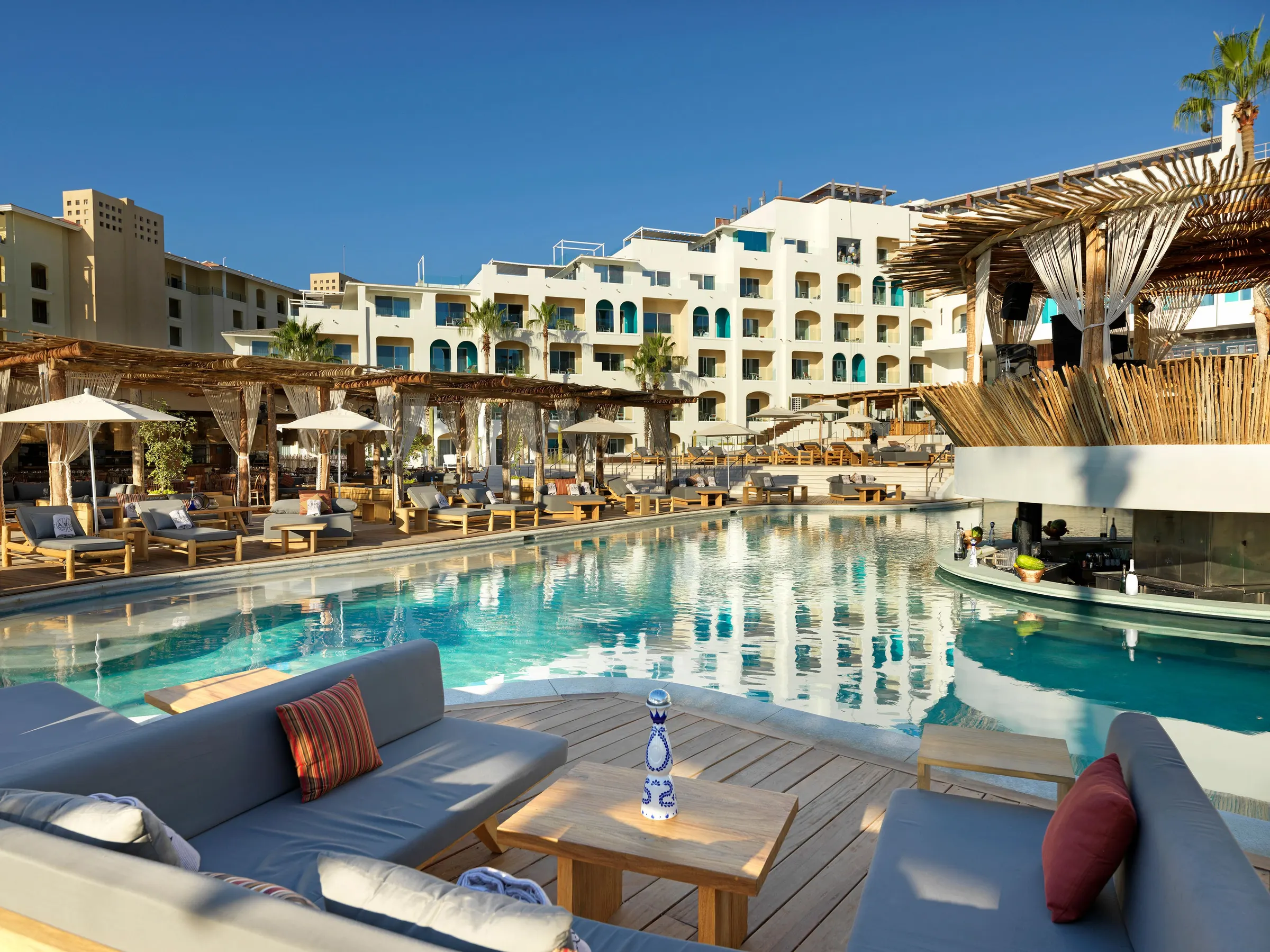 Pool and white resort buildings at ME Cabo