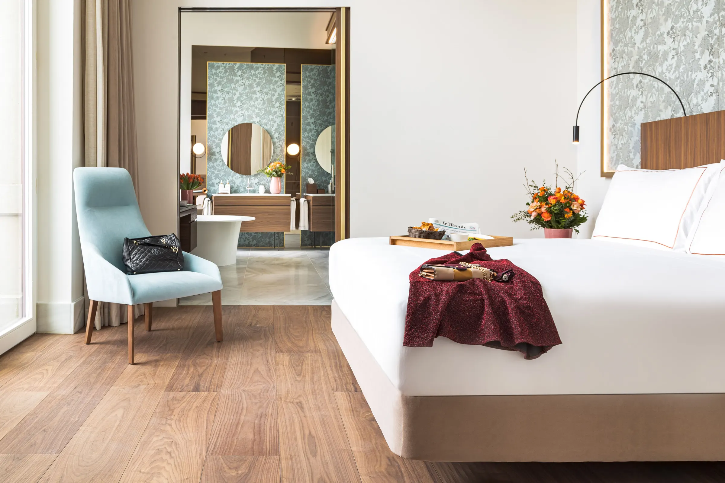 Contemporary bedroom with blue accent chair at Palazzo Cordusio Gran Meliá
