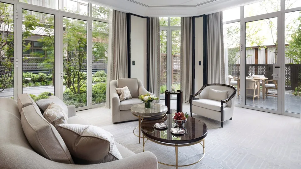 Glazed living room opening towards a garden terrace at The Peninsula Istanbul