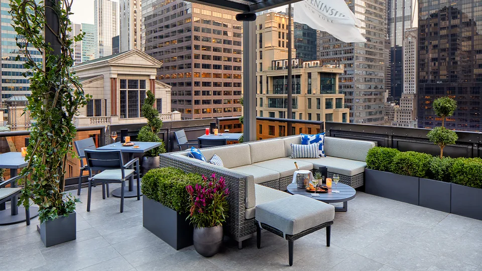 Sofas and terrace tables at Pen Top overlooking Midtown at The Peninsula New York