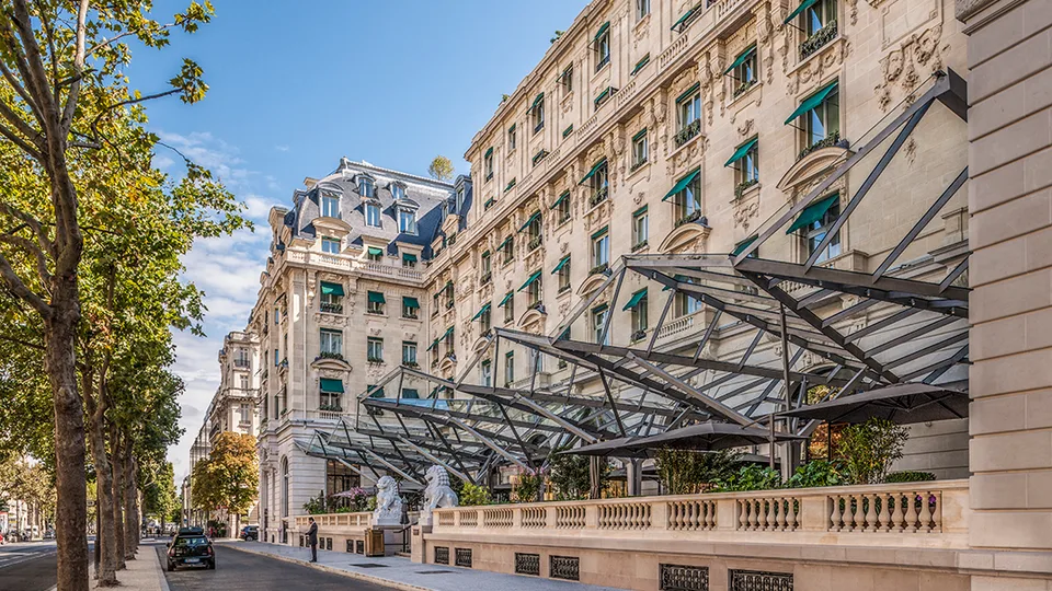 Glass entrance canopy and ornate Avenue Kléber façade at The Peninsula Paris