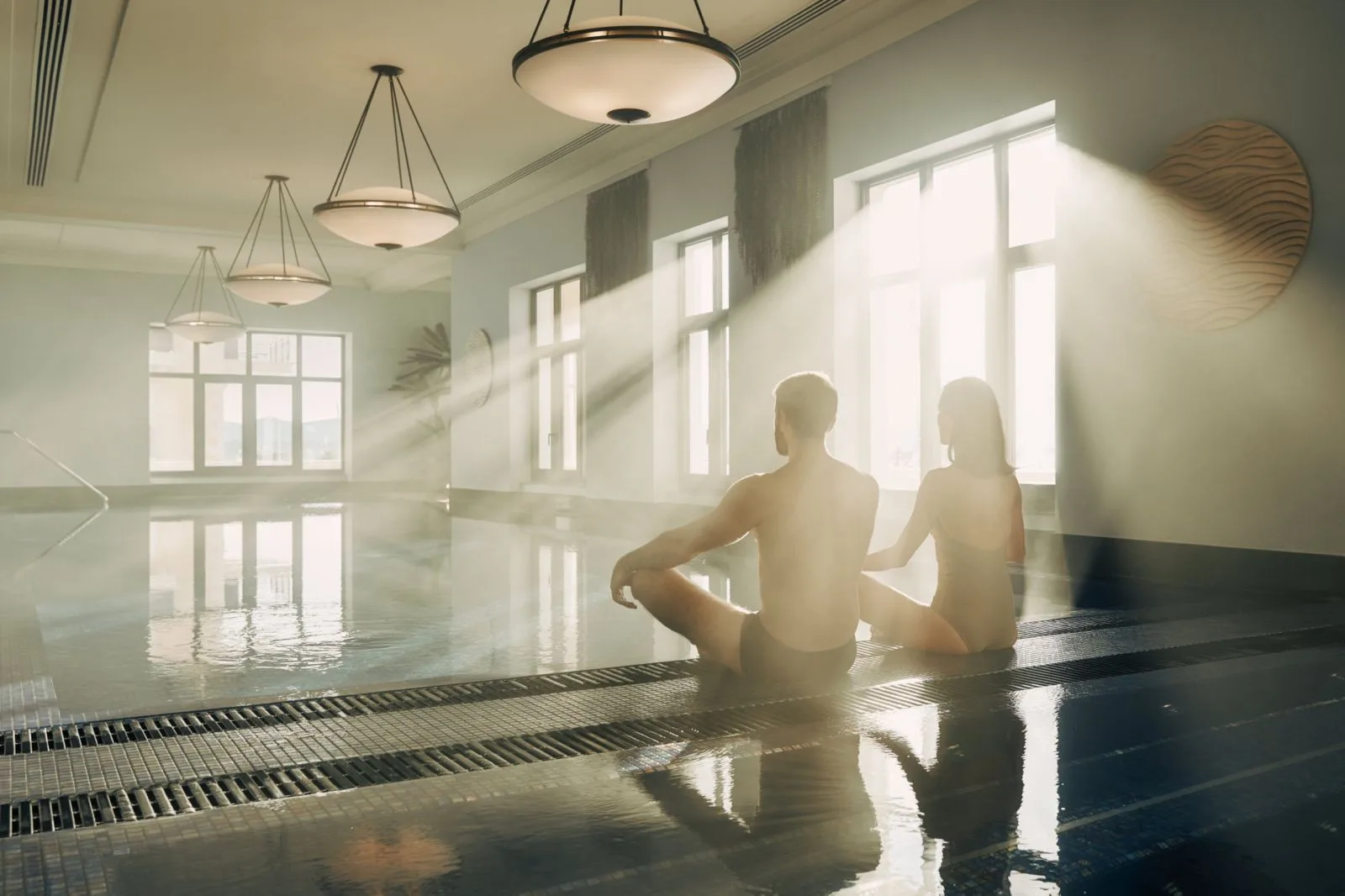 Guests beside the sunlit indoor spa pool at Regent Porto Montenegro